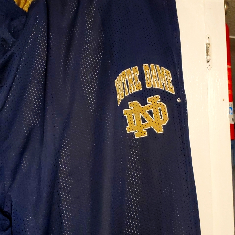 A reversible pair of 5XL Russell Athletic Notre Dame basketball warmup pants